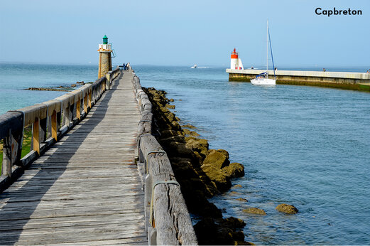 Long wooden pier and lighthouses at the entrance of Capbreton port, Landes.