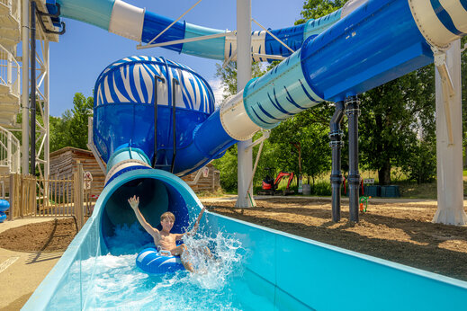 Giant water slide with youth on tube at CAPFUN Ullule campsite in Tournon d'Agenais.
