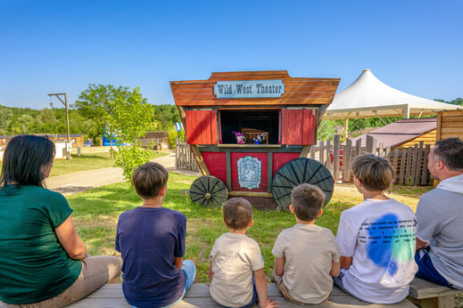 Children watching Wild West puppet show at CAPFUN Ullule campsite Tournon d'Agenais.