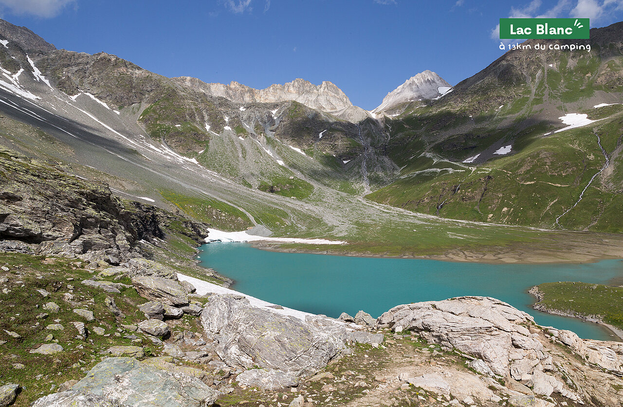 Lac Blanc, turquoise mountain lake surrounded by snowy peaks, near Pralognan.