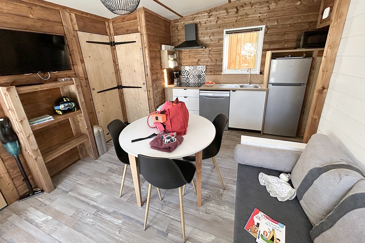 Mobile home: living room, equipped kitchen at CLICOCHIC Alpes Lodges campsite Pralognan.