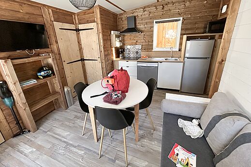 Mobile home: living room, equipped kitchen at CLICOCHIC Alpes Lodges campsite Pralognan.