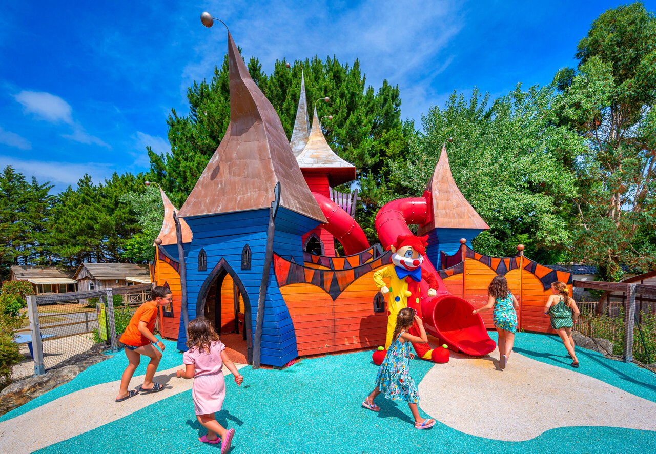 Colorful play castle with slides for children at CAPFUN An Trest campsite in SARZEAU (56).