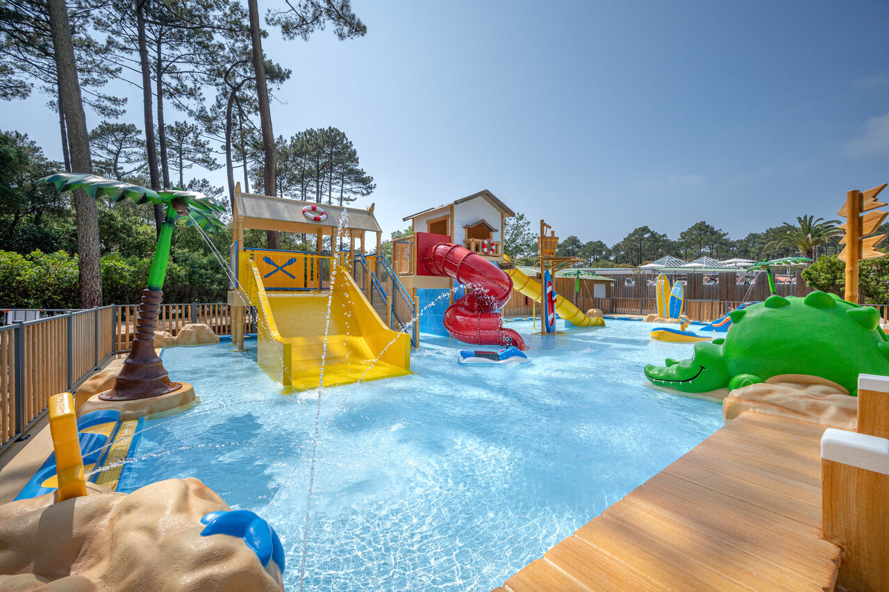Children's water park with slides at LIBRANOO Naturiste Arnaoutchot campsite in Veille-Saint-Girons, Landes, France.