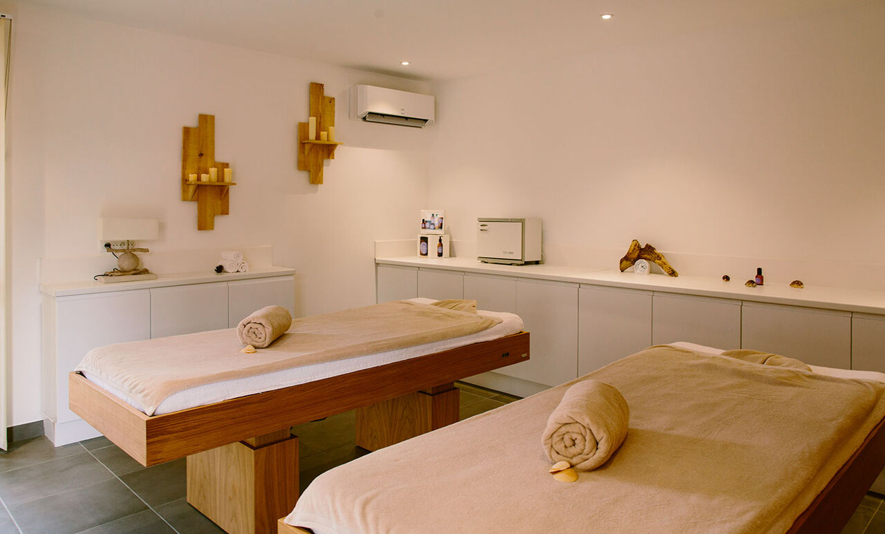 Wellness area with two massage tables at LIBRANOO Naturiste Arnaoutchot campsite in Veille-Saint-Girons, Landes, France.