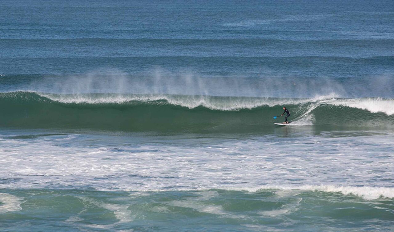 Stand-up paddle on the ocean at LIBRANOO Naturiste Arnaoutchot campsite in Veille-Saint-Girons, Landes, France.