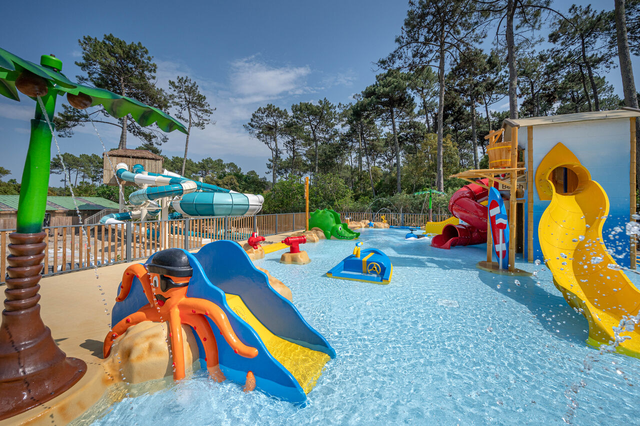 Water park with slides and water games at LIBRANOO Naturiste Arnaoutchot campsite in Veille-Saint-Girons, Landes, France.