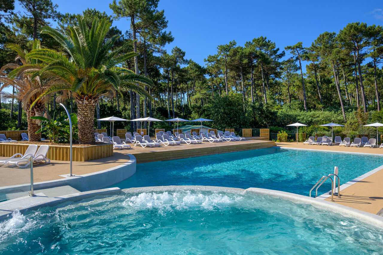 Outdoor pool, jacuzzi, sun loungers at LIBRANOO Naturiste Arnaoutchot campsite in Veille-Saint-Girons, Landes, France.