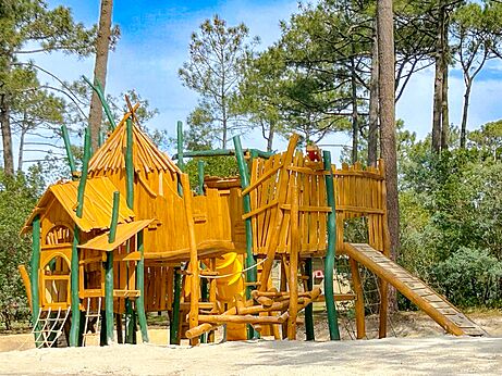Wooden play structure for children at LIBRANOO Naturiste Arnaoutchot campsite in Veille-Saint-Girons, Landes, France.