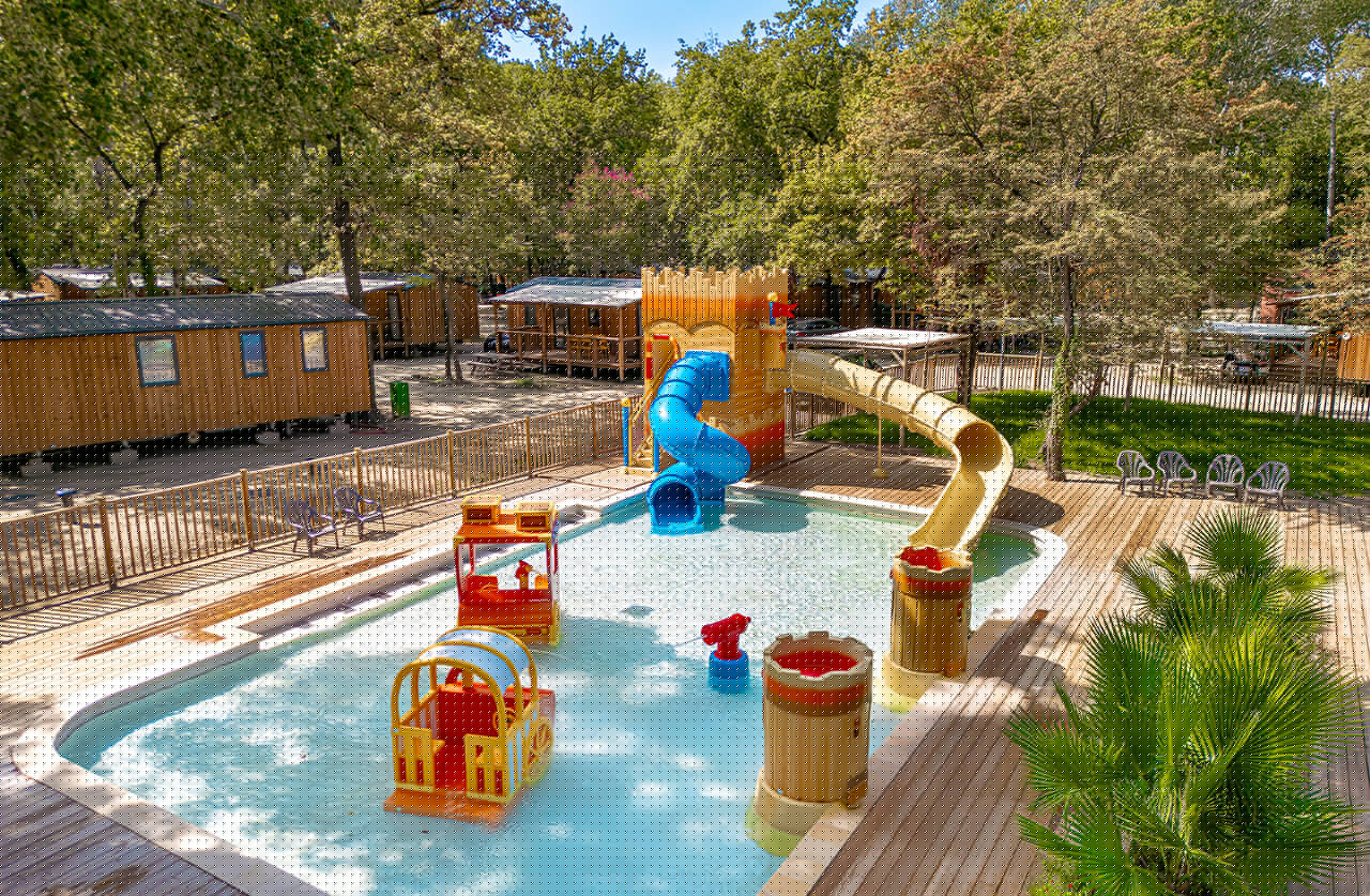 Children's pool, slides, water games at CLICOCHIC Art de Vivre campsite.