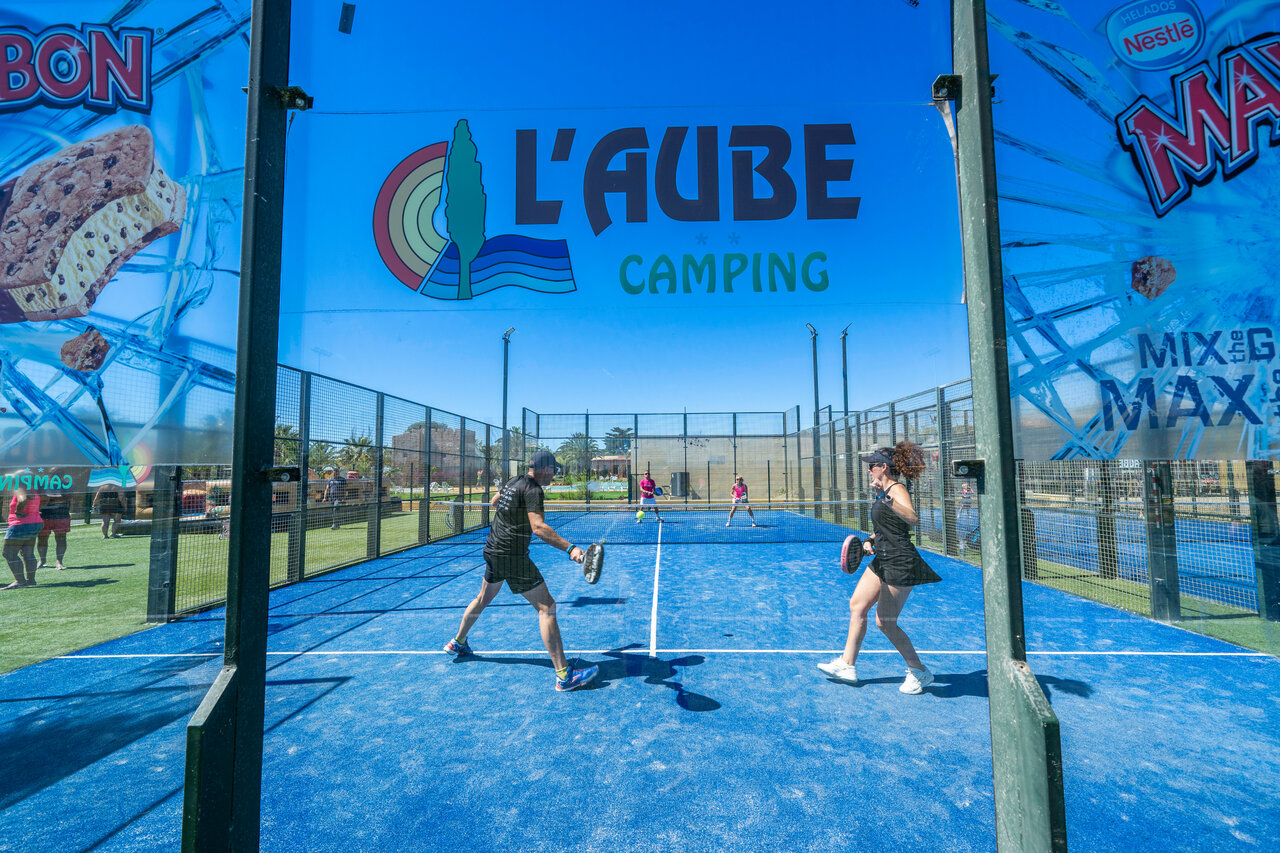 Players on blue padel court at CAPFUN Aube campsite, Deltebre.