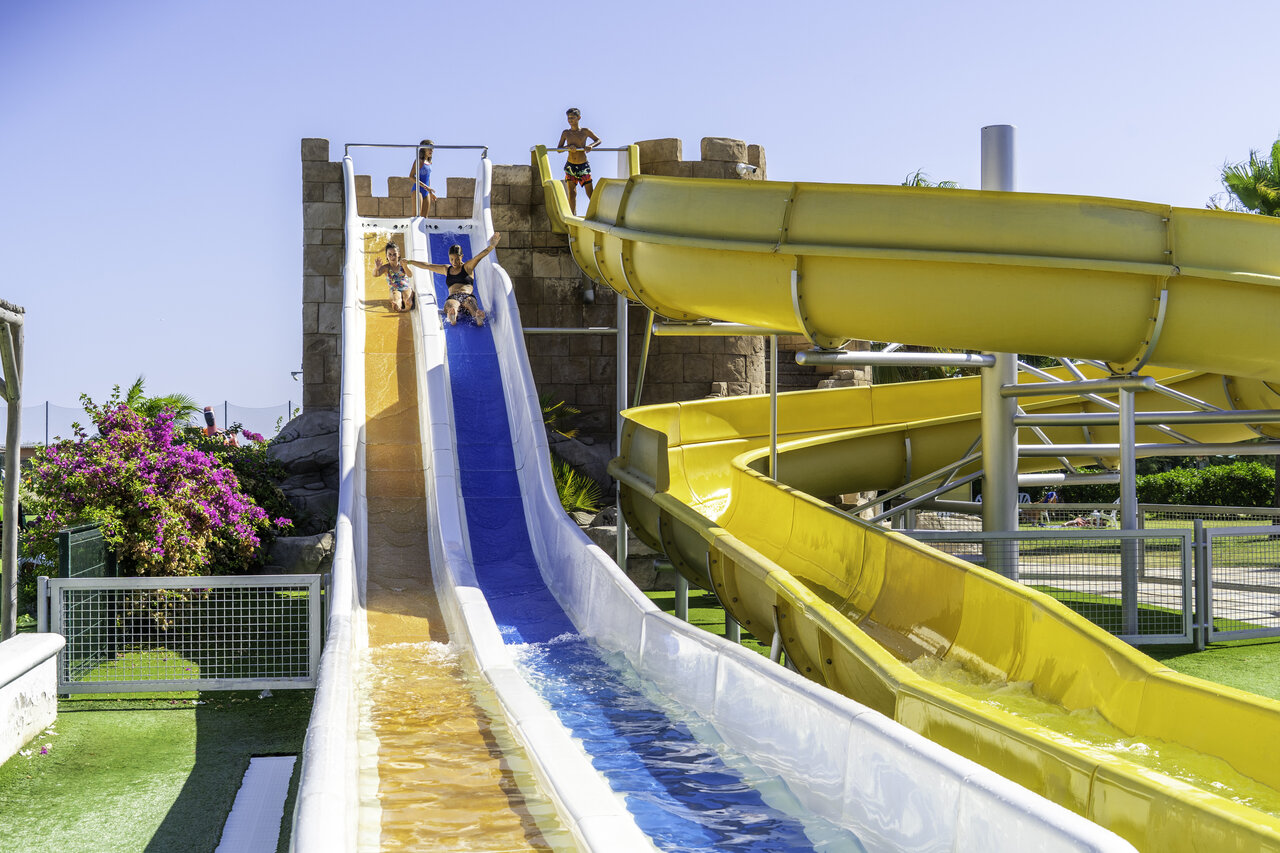 Colorful water slides and children at CAPFUN Aube campsite in Deltebre, Tarragona.