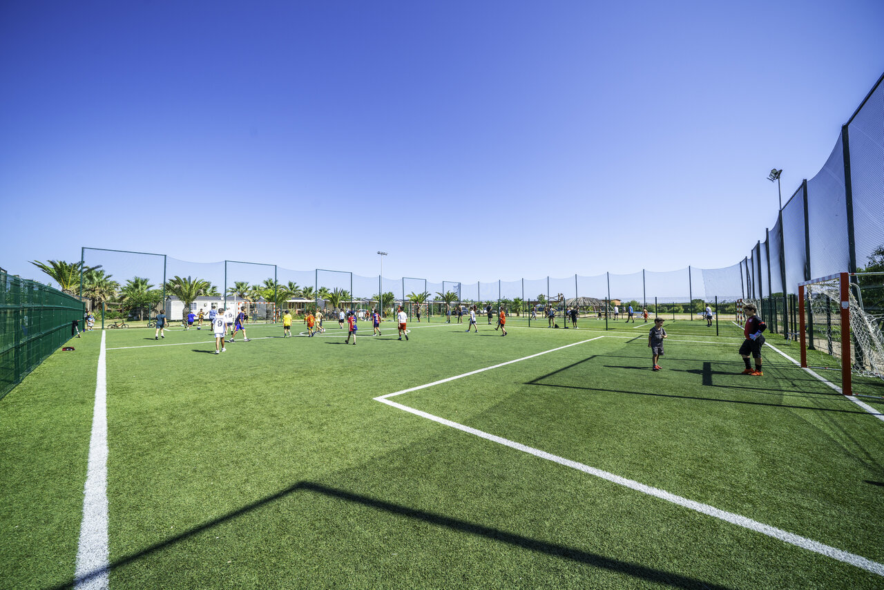 Football match on synthetic multi-sport pitch at CAPFUN Aube campsite in Deltebre, Tarragona.