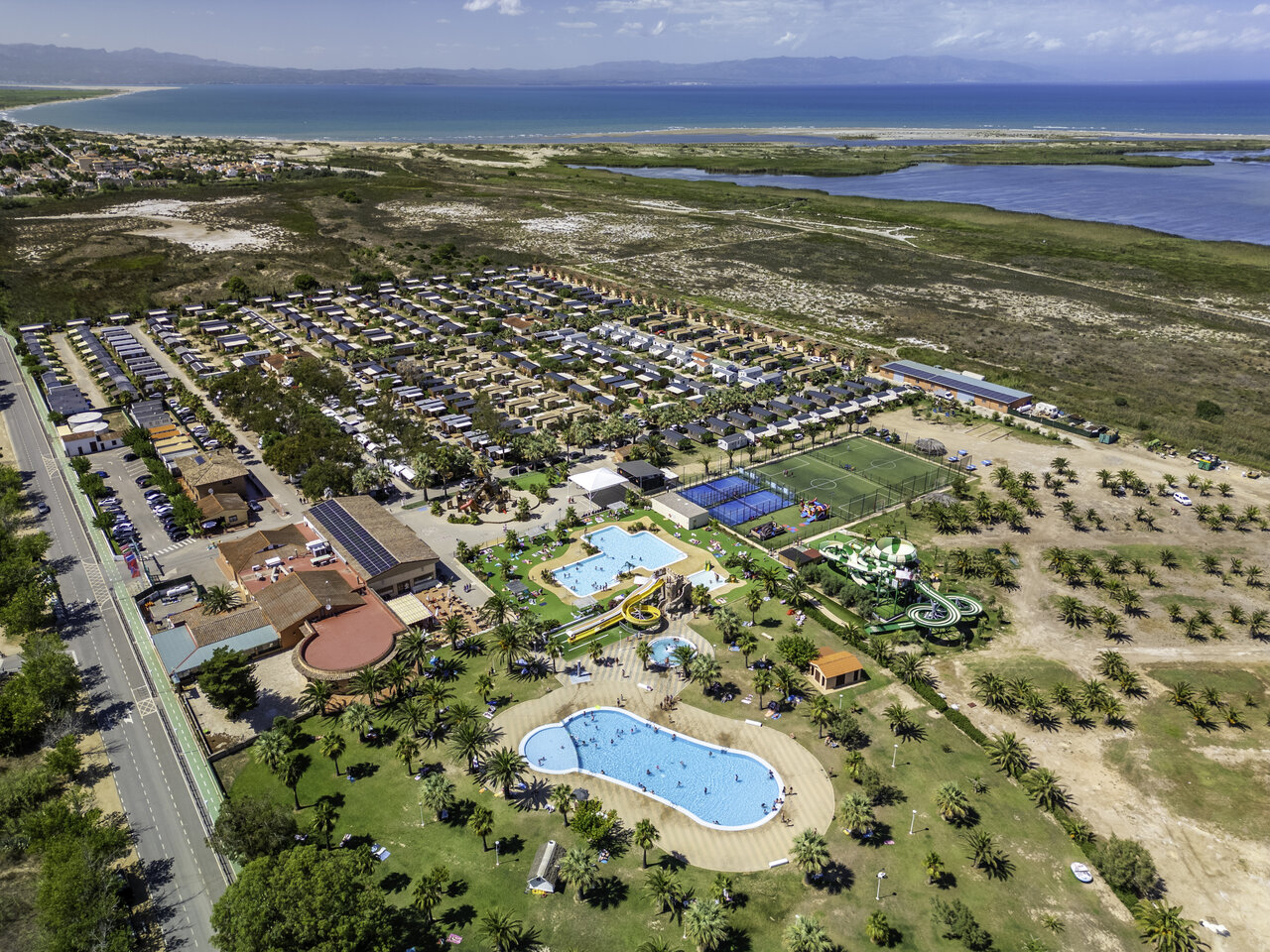 Aerial view CAPFUN Aube campsite Deltebre: pools, slides, mobile homes, sports.