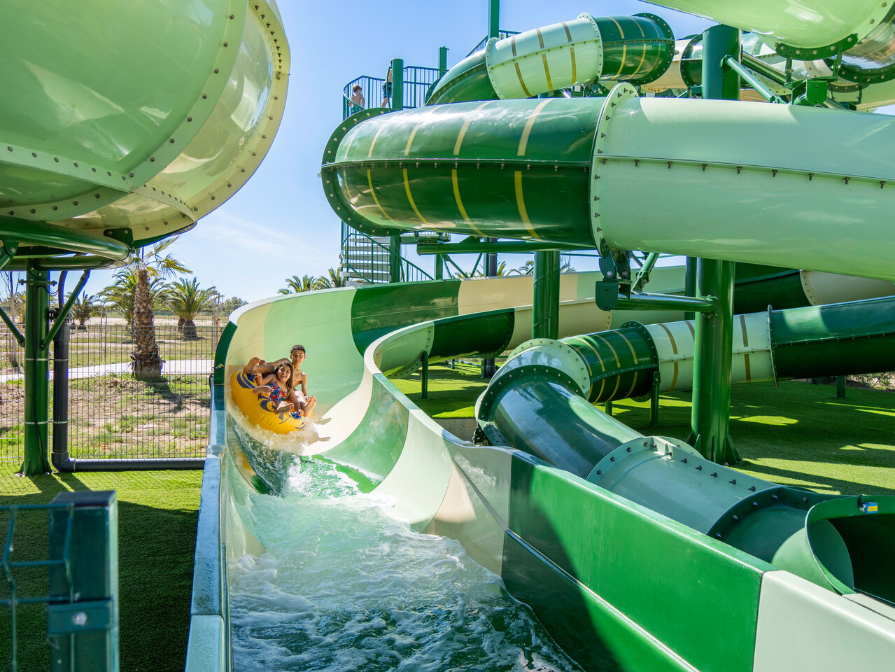Water slide with children on inflatable at CAPFUN Aube, Deltebre, Tarragona.