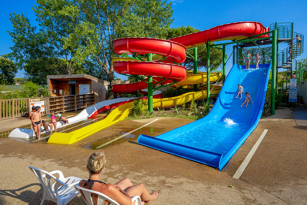 Colorful water slides and happy children at CAPFUN Aubr�des campsite in Puget sur Argens (83).