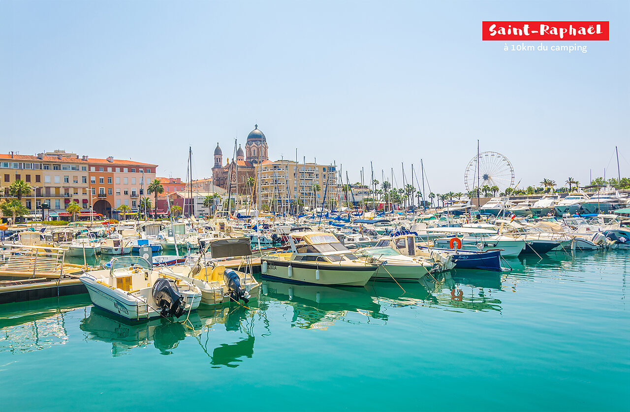 Lively marina of Saint-Rapha�l with boats, church and Ferris wheel, French Riviera.