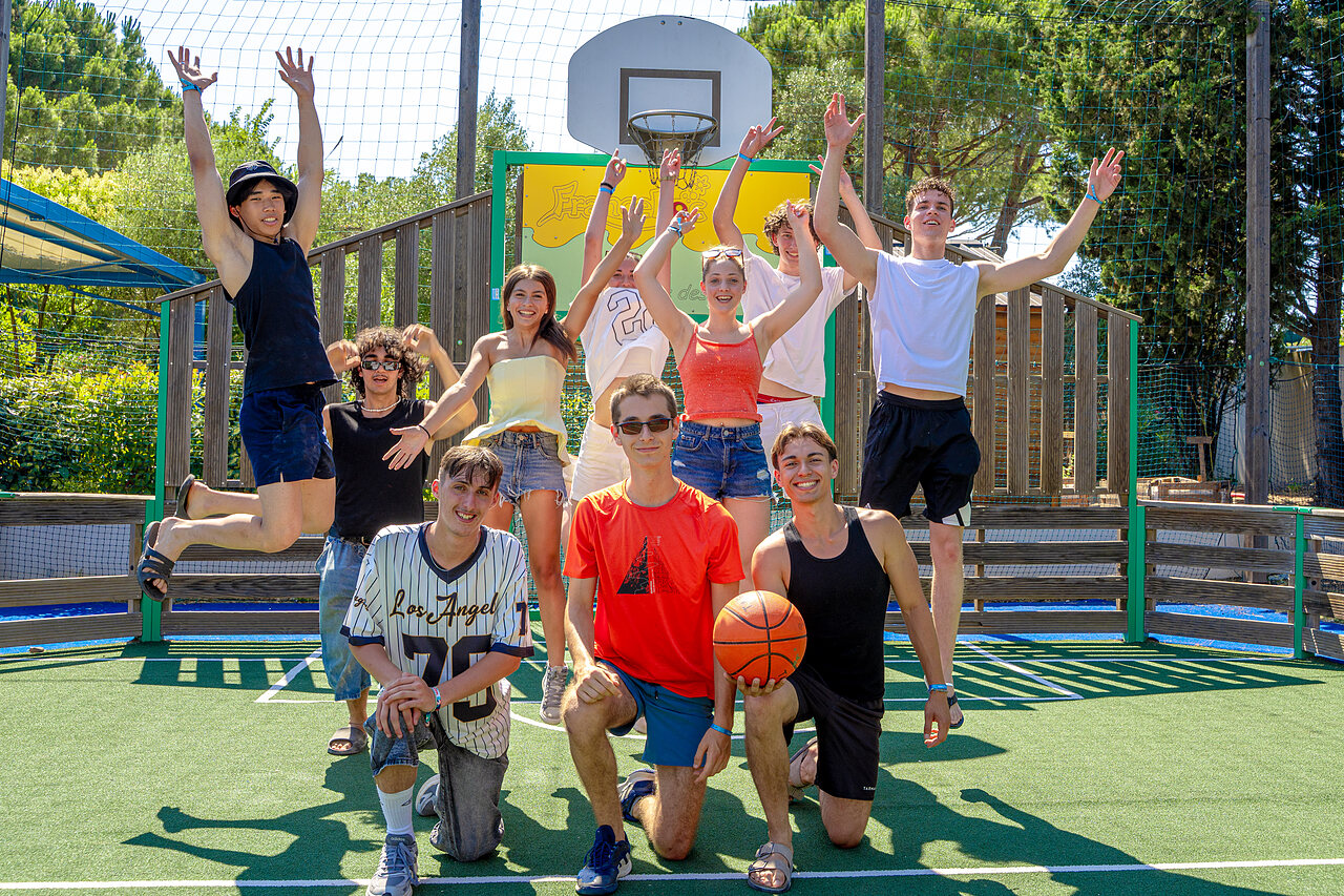 Active young people on multi-sport court with basketball at CAPFUN Aubr�des in Puget sur Argens.
