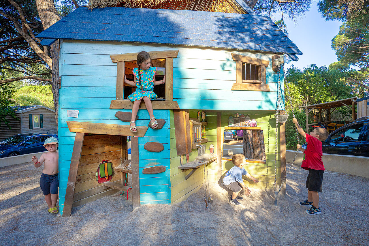 Kids playing in the playhouse at CAPFUN Aubr�des, Puget sur Argens (83).