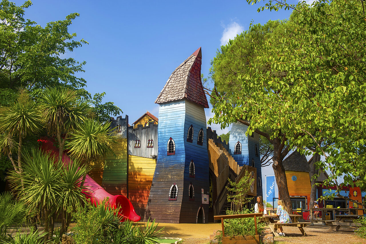 Colorful castle playground with slide at CAPFUN Aubr�des campsite in Puget sur Argens (83).