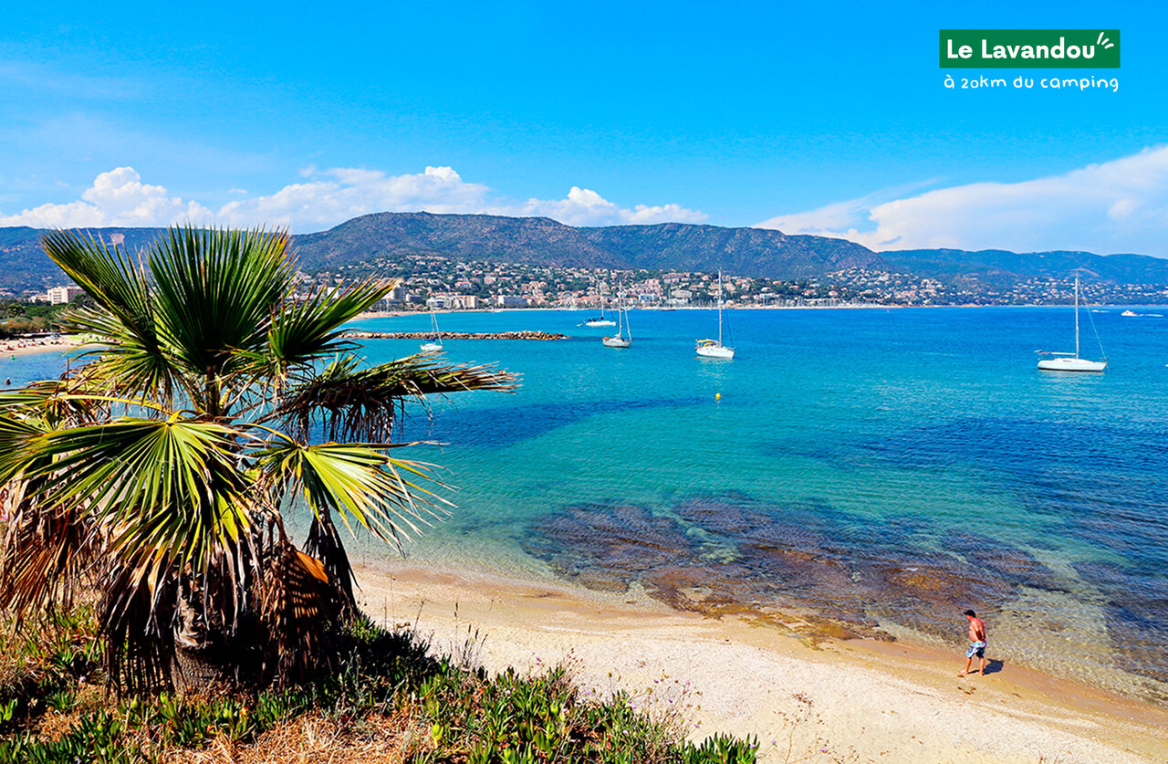 Fine sandy beach and turquoise sea in Le Lavandou, French Riviera.