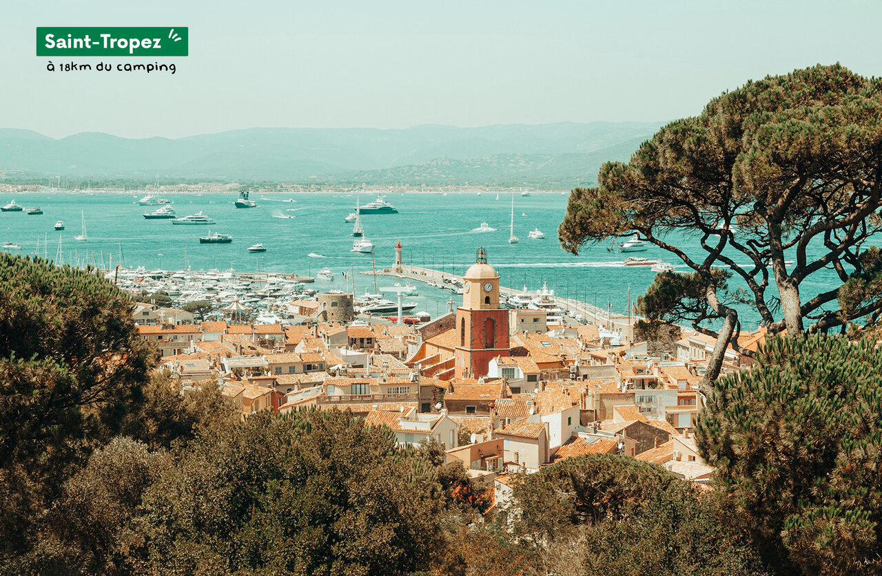 Port of Saint-Tropez with its bell tower and typical houses, French Riviera.