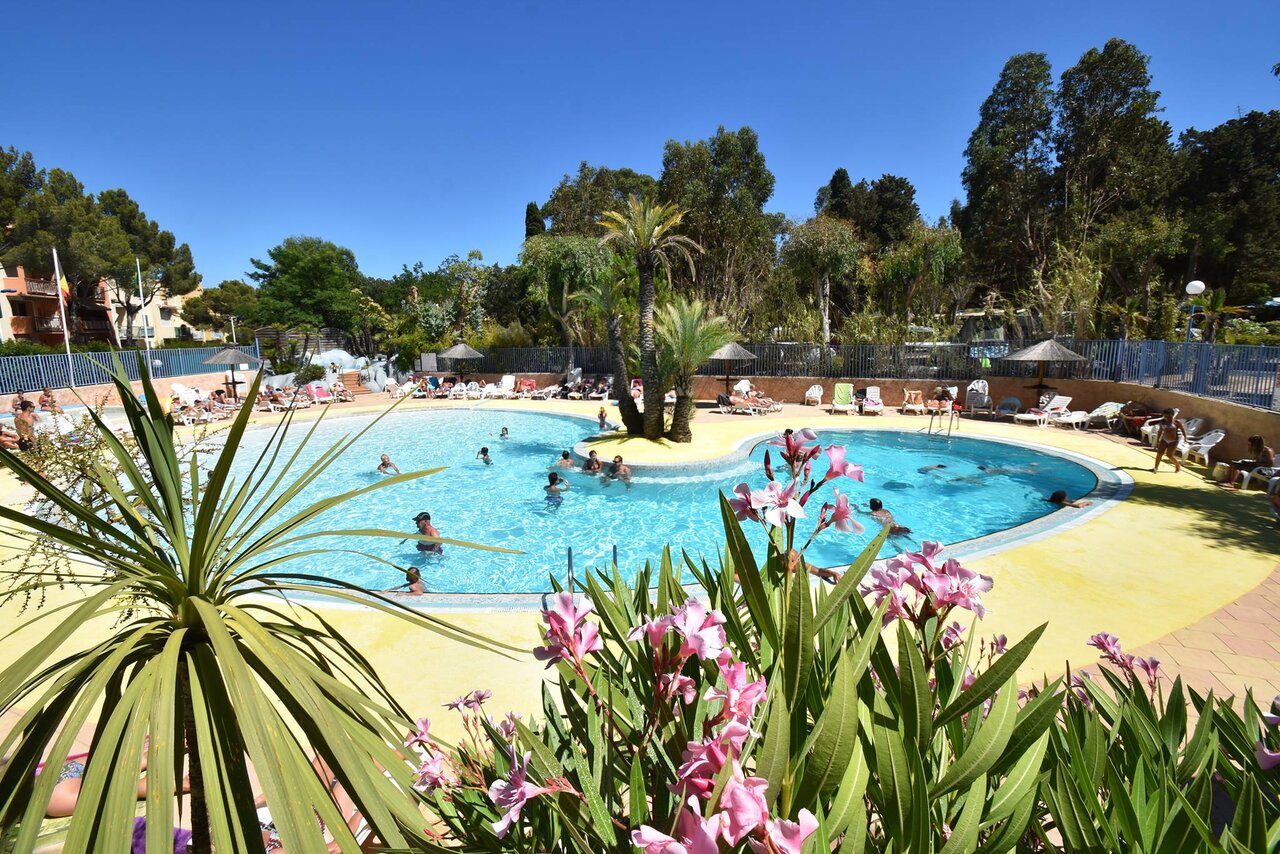 Outdoor lagoon pool, island and waterfall at CLICOCHIC campsite in Cavalaire-sur-Mer.