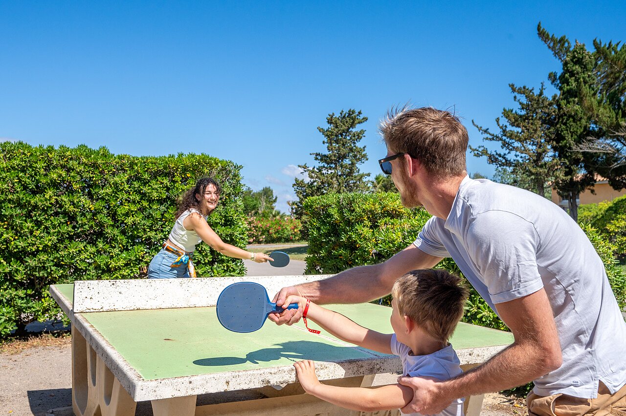 Family playing table tennis on outdoor table, CAPFUN Barbacane campsite in Narbonne.