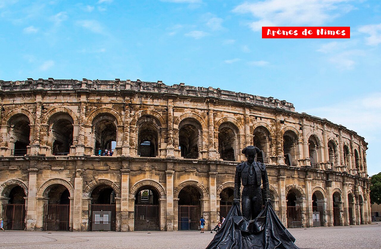 Roman amphitheater Ar�nes de N�mes with bullfighter statue in N�mes, Occitania.