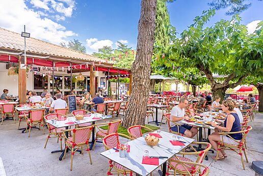 Outdoor restaurant terrace with diners at CAPFUN Bastide campsite in N�mes (30).