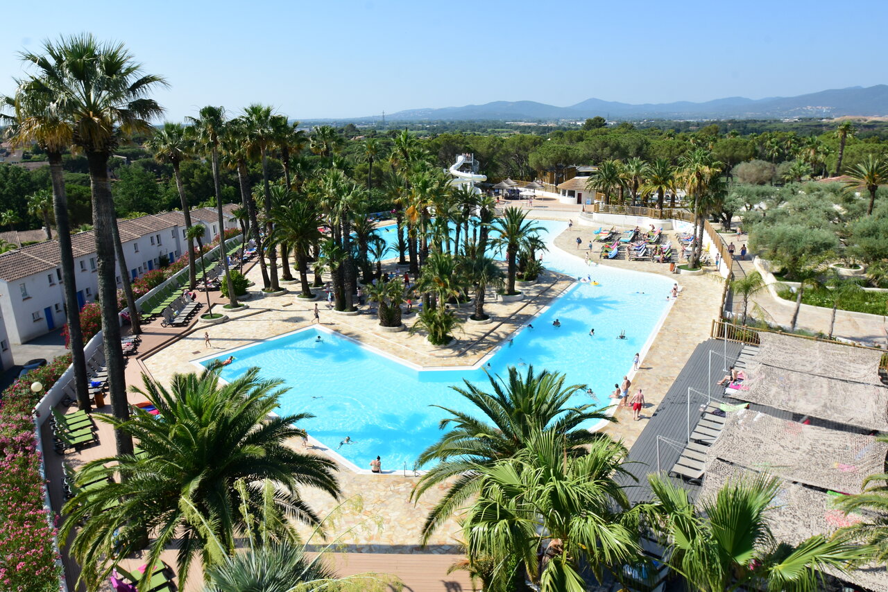 Outdoor pools, water slide, palm trees at CAPFUN La Baume - La Palmeraie in Fr�jus (83).