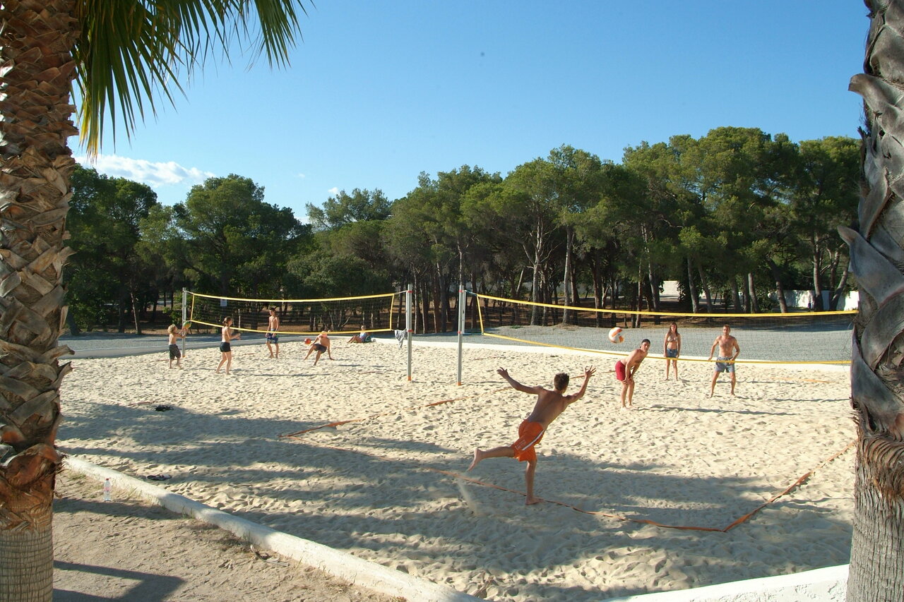 Beach volleyball court with players at CAPFUN La Baume - La Palmeraie Fr�jus (83).