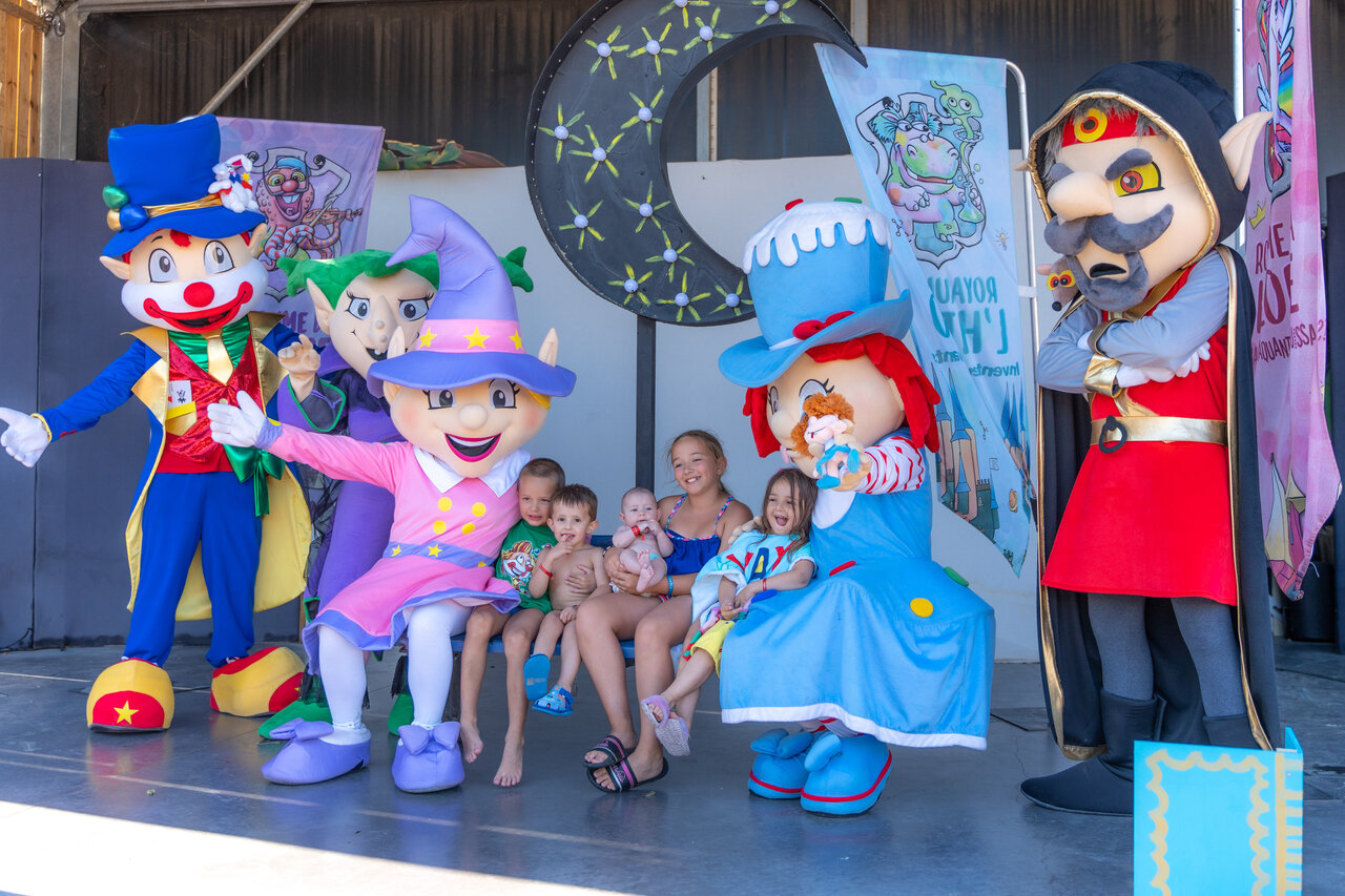 Mascots and smiling children at an animation show at CAPFUN Beauregard campsite in MORNAS (84).