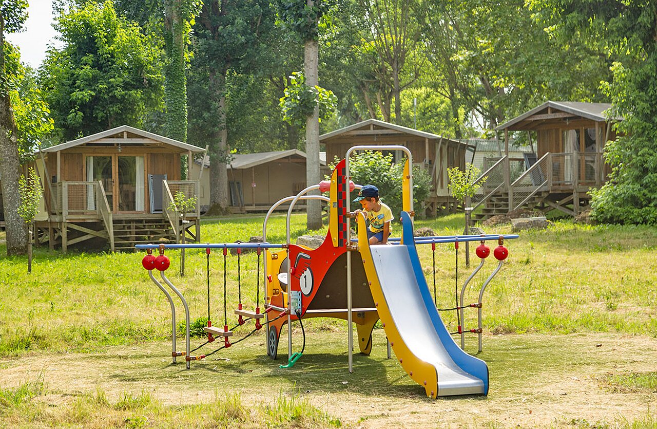 Child on playground with slide, Mobile homes at camping CLICOCHIC Beau Rivage (24).