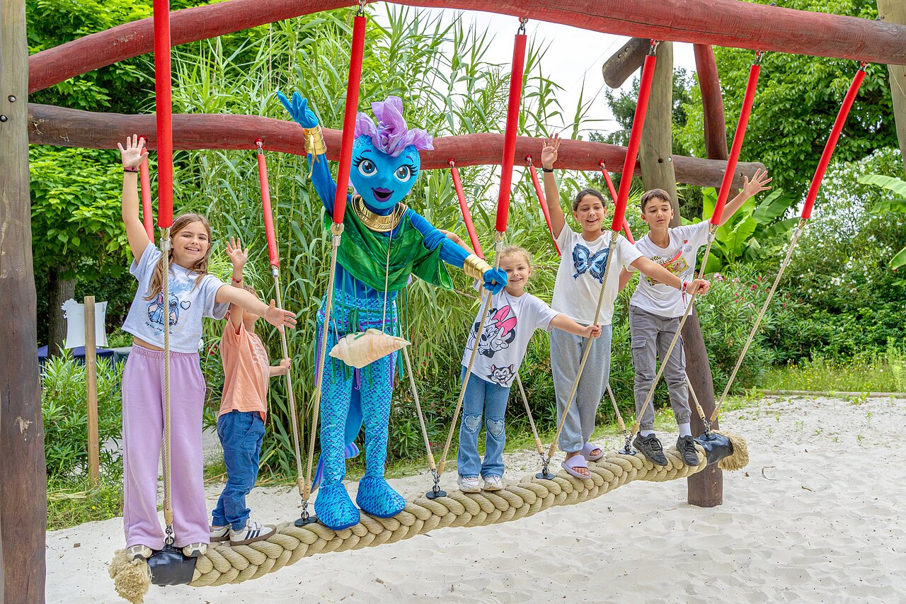 Children and mascot on rope bridge, playground at camping CLICOCHIC Beau Rivage in LA ROQUE-GAGEAC (24).