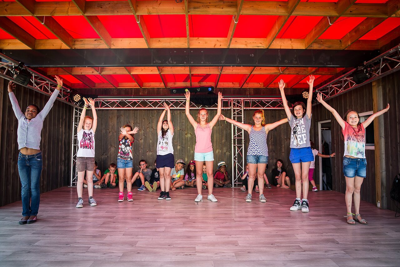 Children on stage participating in an animation at CAPFUN Bel Air campsite in Aiguillon sur Mer (85).