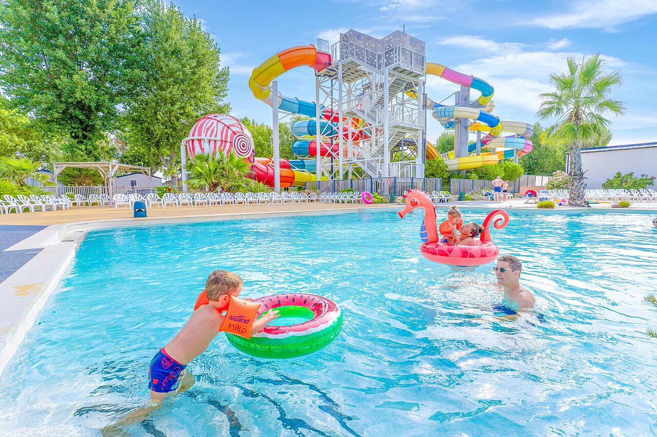 Outdoor pool, water slides and children at CAPFUN Bel Air campsite in Aiguillon sur Mer.