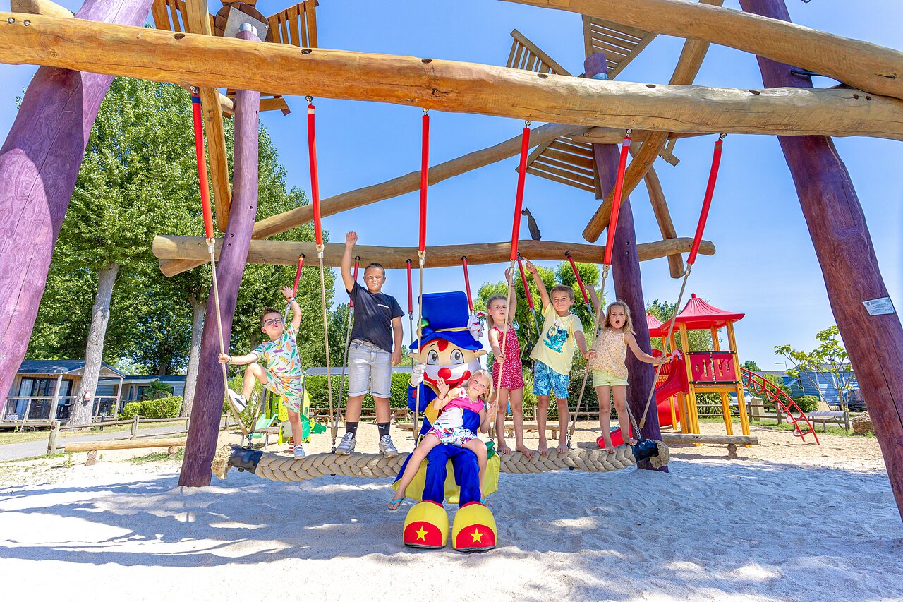 Giant swing, children, mascot at CAPFUN Bel Air campsite in Aiguillon sur Mer.