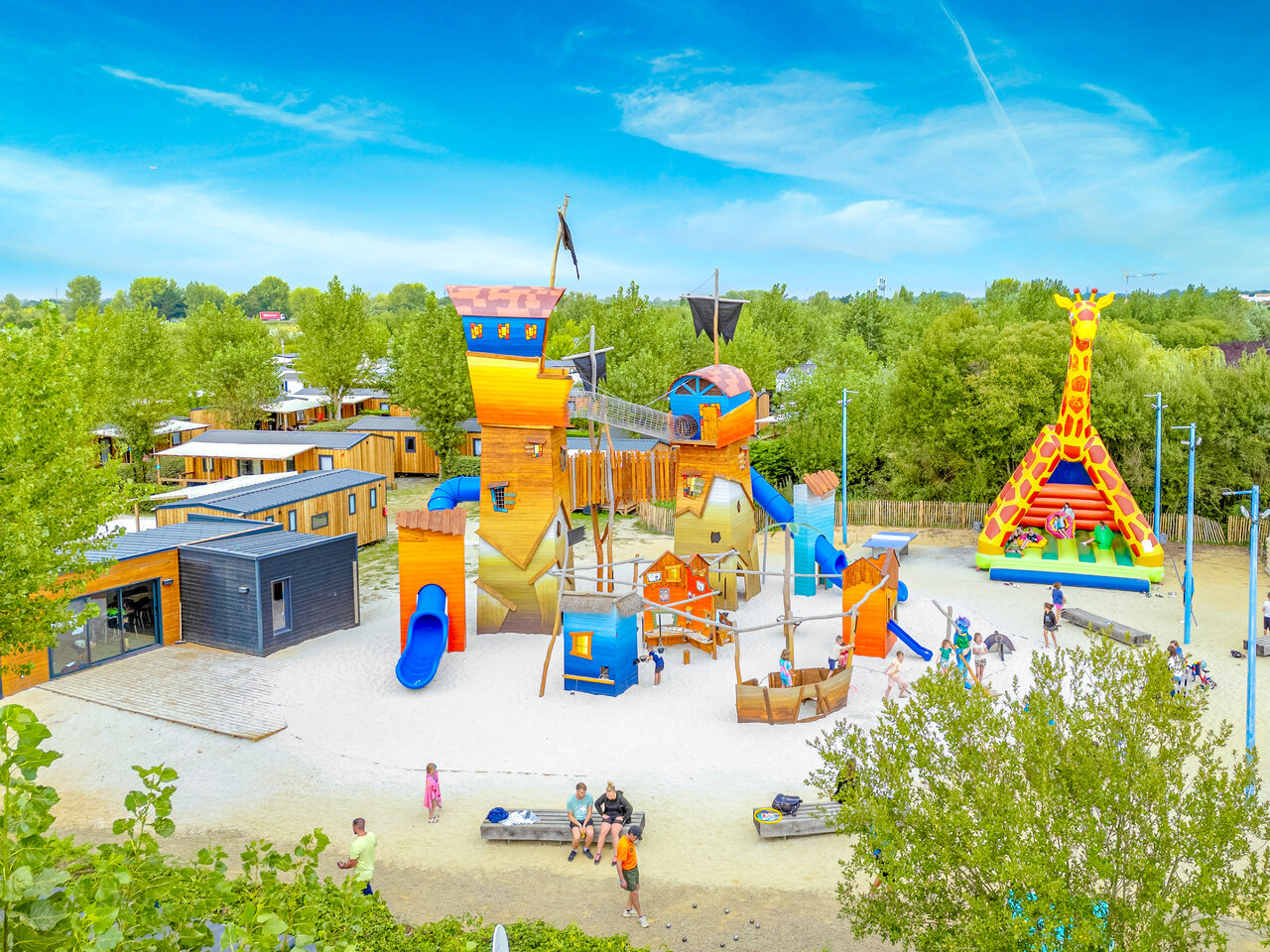 Children's playground, pirate castle, inflatable giraffe at VAGUES OCEANES Bois Joly campsite.