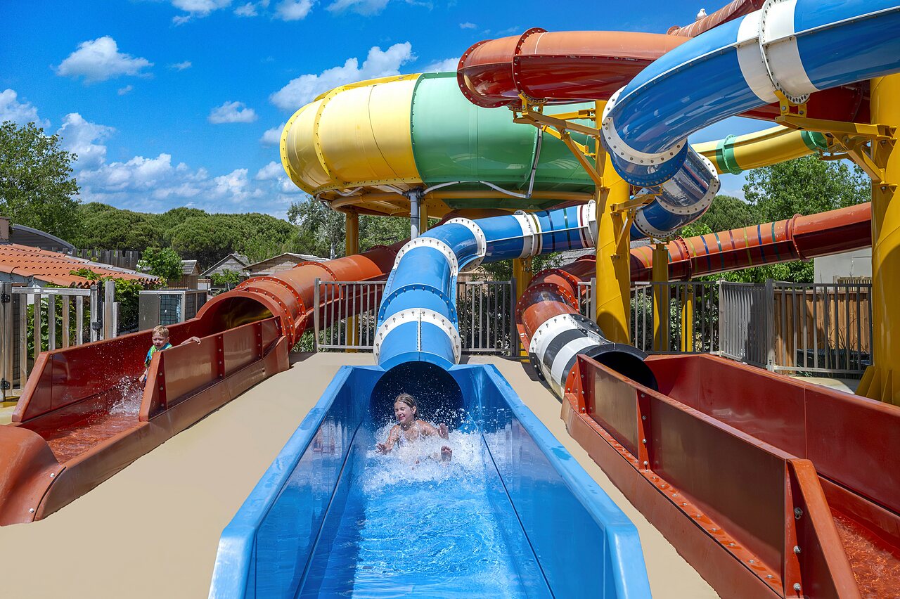 Colorful water slides and children having fun at CAPFUN Boucanet campsite in LE GRAU DU ROI (30).