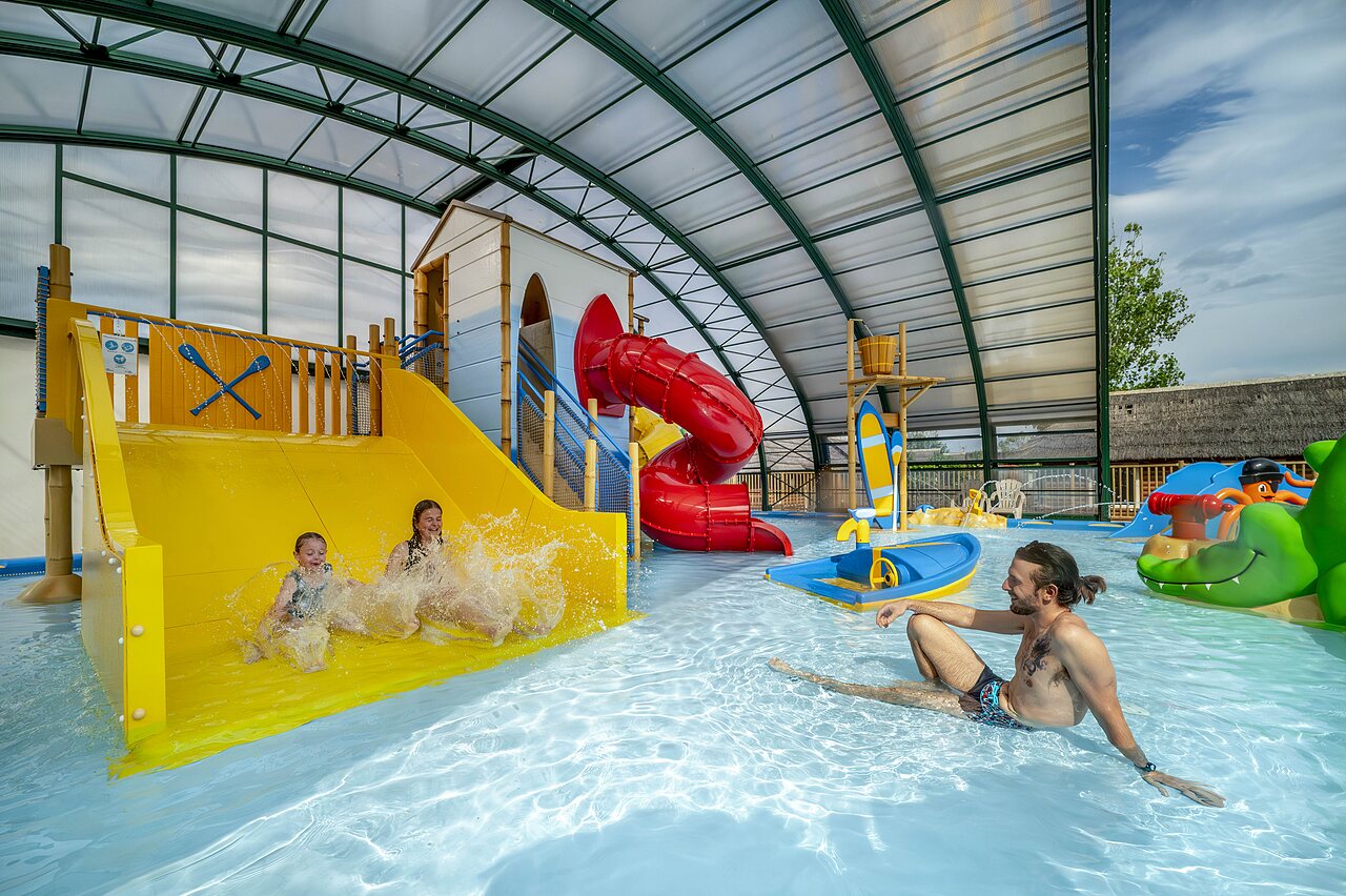 Indoor pool, waterslides, water games, children at CAPFUN Boucanet campsite.
