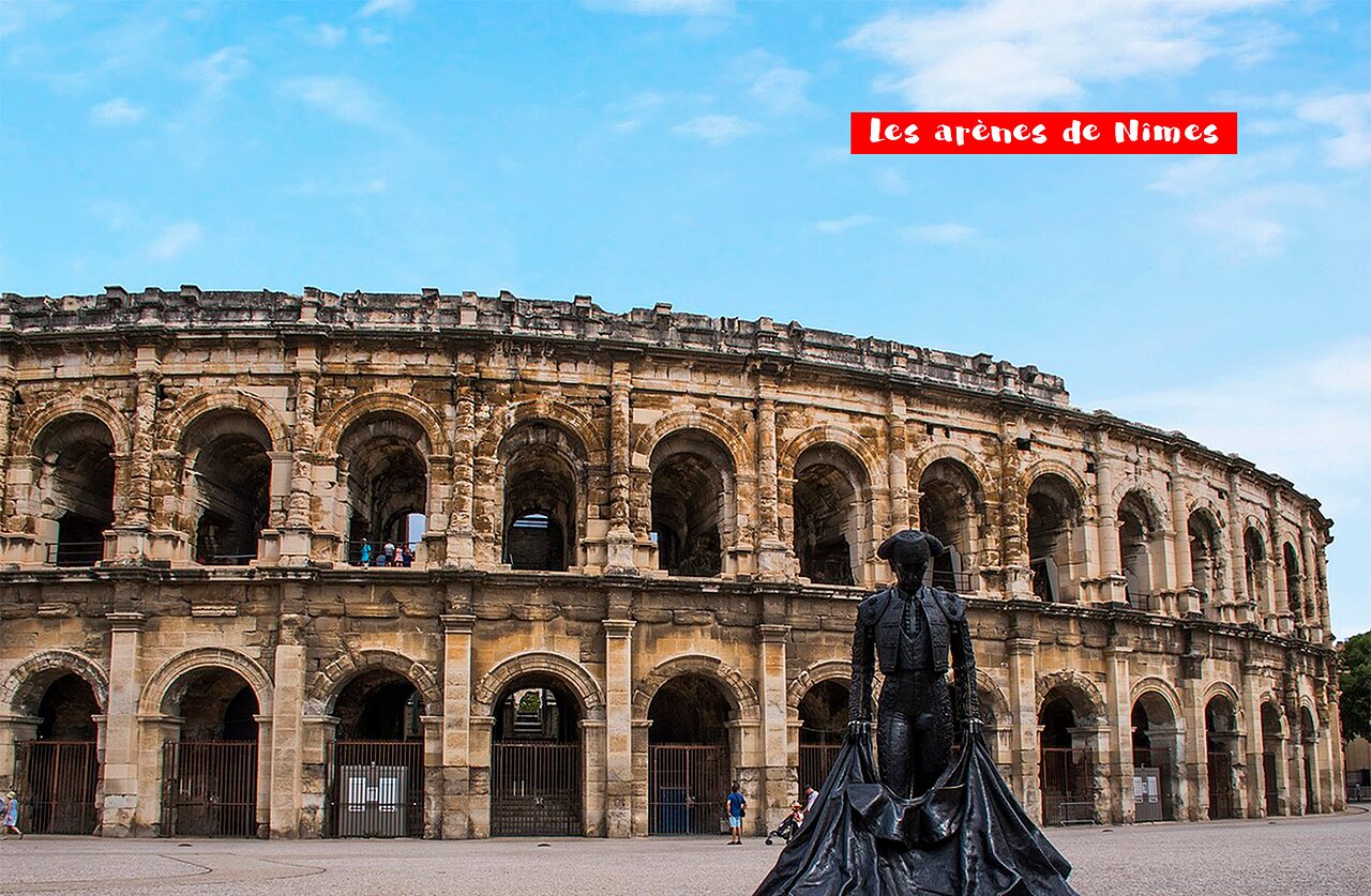 Historic Roman amphitheater of N�mes, with bullfighter statue, a must-visit.