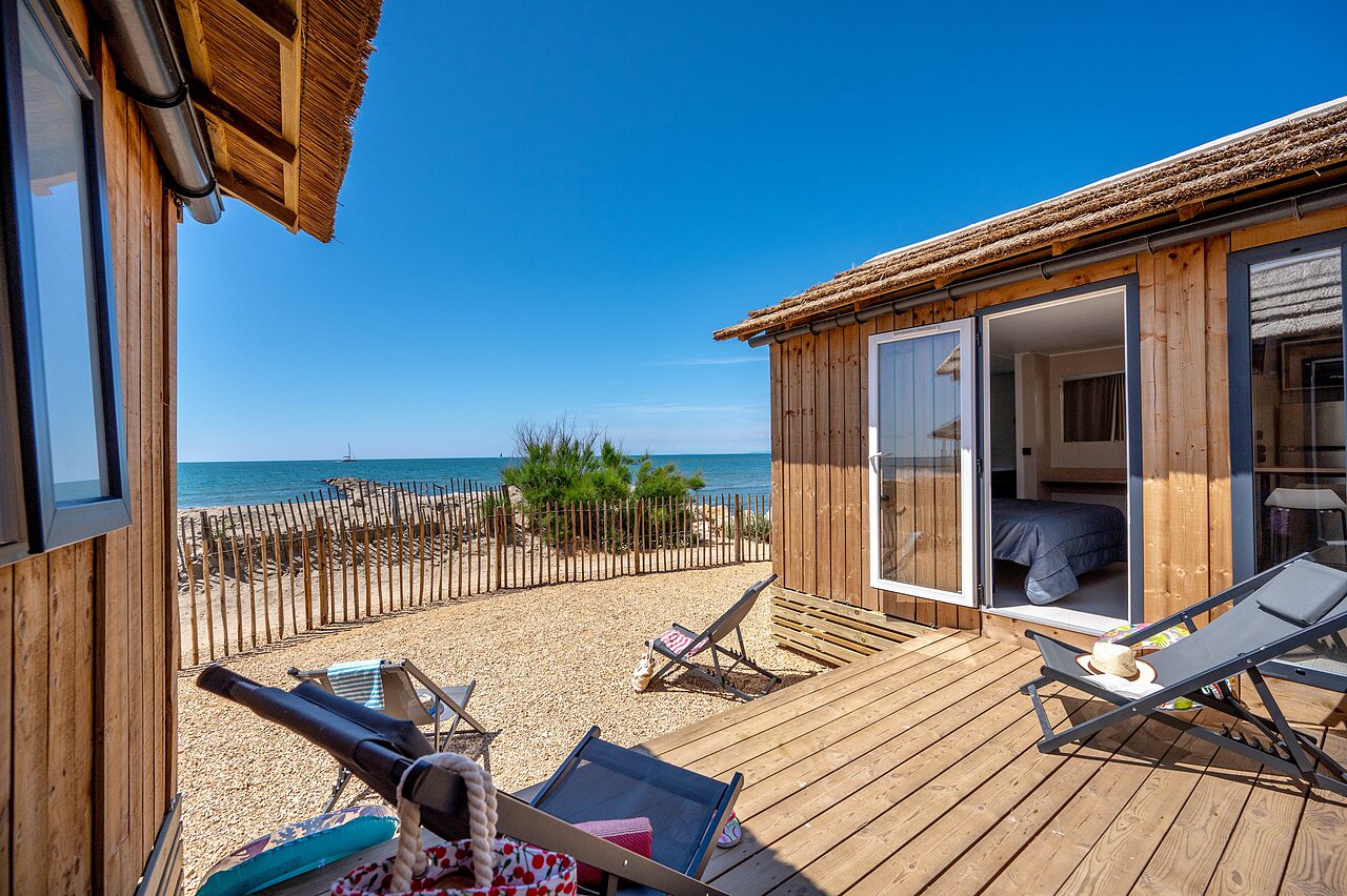 Wooden chalet, terrace, sea view, at CAPFUN Boucanet campsite in LE GRAU DU ROI (30).