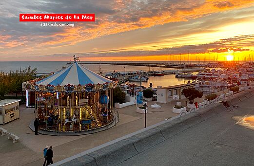 Carousel and marina at sunset in Saintes Maries de la Mer.