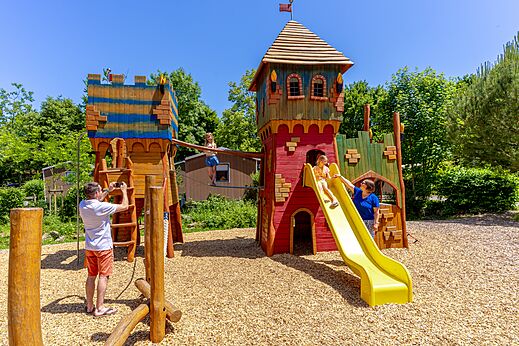 Castle playground with slide and children at CAPFUN Breteche campsite in Les Epesses (85).