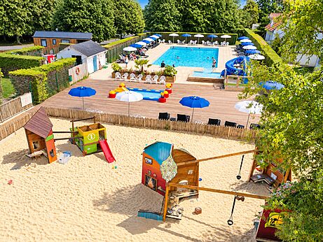Swimming pool, slide and playground at CLICOCHIC Brise de Cabourg campsite.