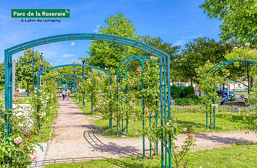 Flowered path with rose arches in the Roseraie Park, close to the campsite.