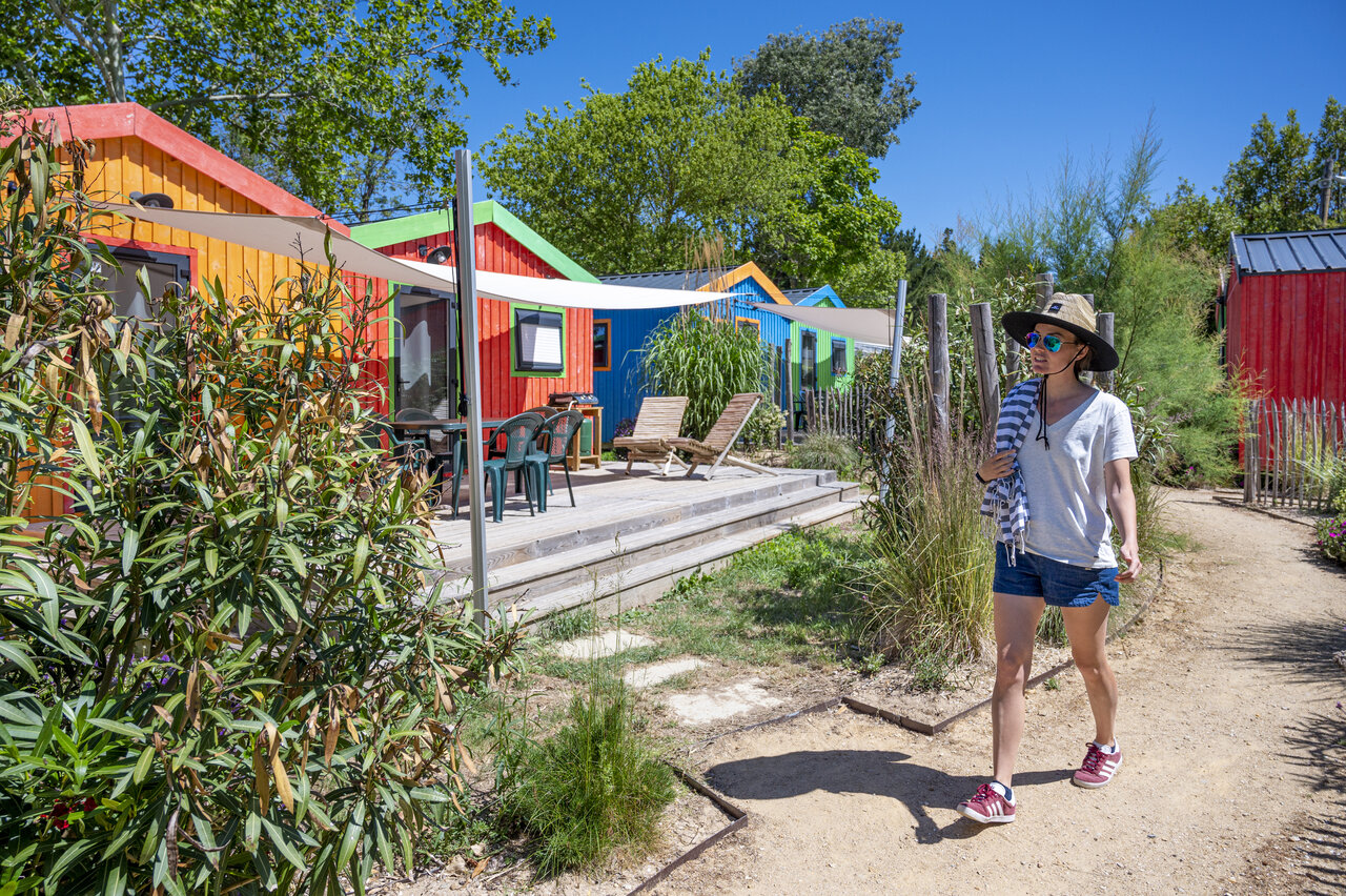 Colorful cabins with wooden terraces at camping CLICOCHIC Cabanes d Ol�ron in ST GEORGES D'OLERON (17).
