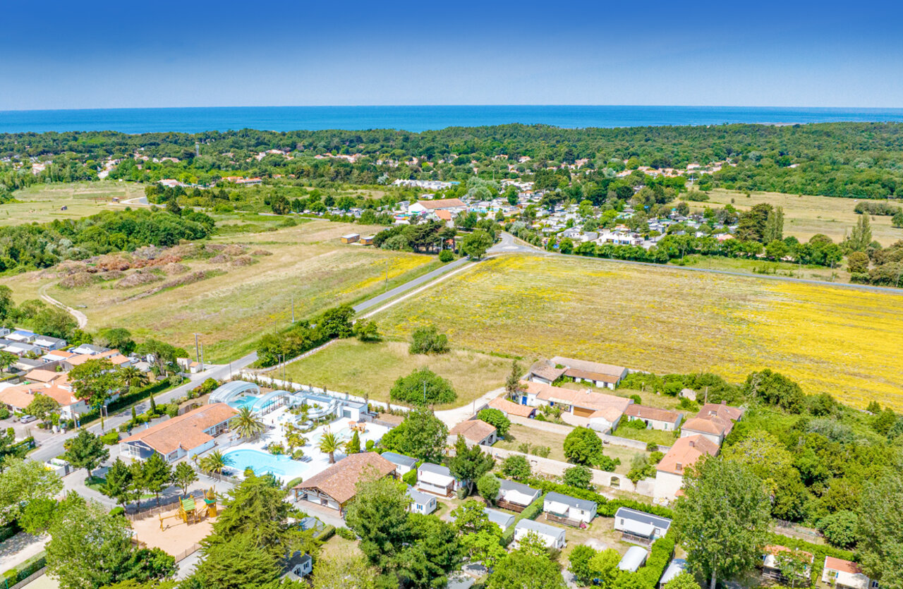 Aerial view pool, waterslides, mobile homes at CLICOCHIC Cabanes d Ol�ron campsite in ST GEORGES D'OLERON.