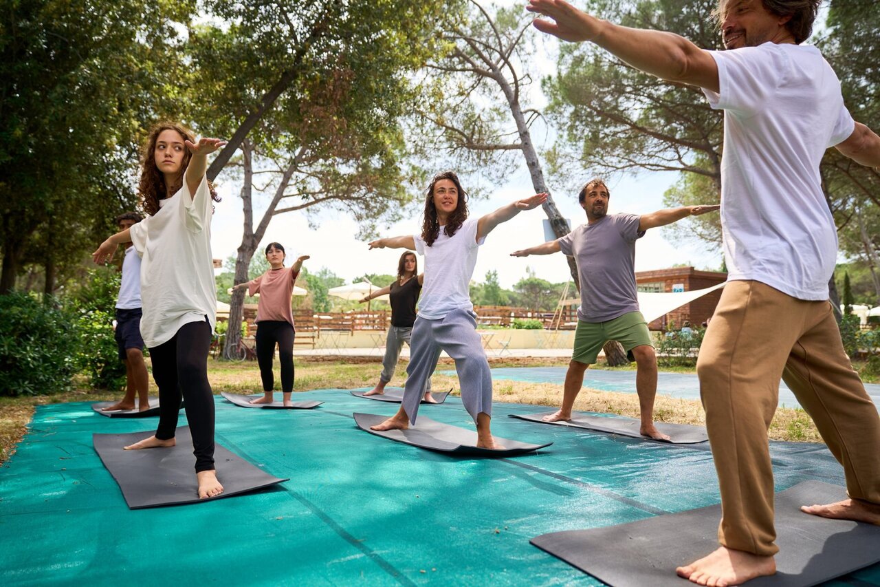 Outdoor yoga session at CAPFUN Campo dei Fiori campsite in Rosignano Marittimo.